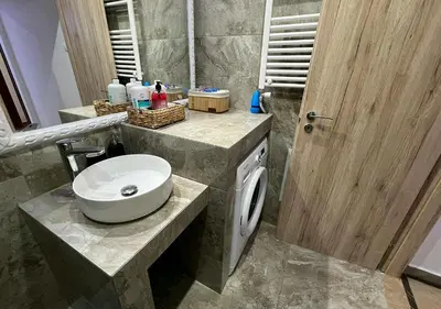 a bathroom with a sink and a washing machine at Sea View Studio in Athens