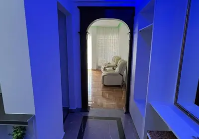 a hallway with blue walls and a living room at Sea View Studio in Athens