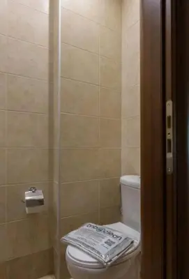 a bathroom with a toilet and a glass shower at Spacious 3bdr apart w/balcony-5 mins to acropolis in Athens