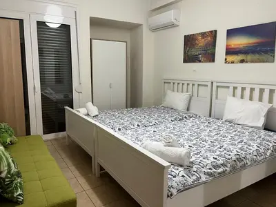 a bedroom with a bed with a teddy bear on it at Spacious 3bdr apart w/balcony-5 mins to acropolis in Athens