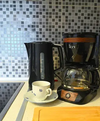 a coffee maker and a coffee cup on a counter at Seaside Bliss in Varkiza - Dreamy Balcony with Stunning Sea Views in Varkiza