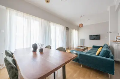a living room with a table and a couch at Spacious 2BDs Apt With Acropolis View In Center in Athens