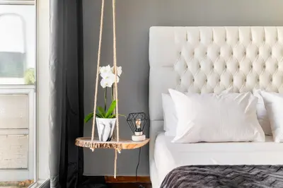 a bedroom with a large white bed with a rope bed frame at Eclipse Glyfada Beach in Athens