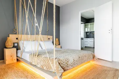a bedroom with a hanging bed in a room at Eclipse Glyfada Beach in Athens