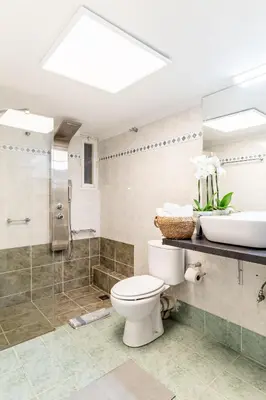 a bathroom with a toilet and a sink at Eclipse Glyfada Beach in Athens