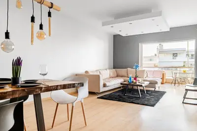 a living room with a couch and a table at Eclipse Glyfada Beach in Athens