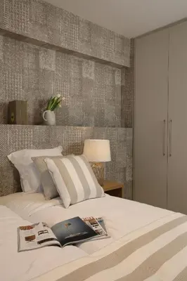 a bedroom with a bed with a book on it at Joy Luxury Central Apartment in Athens