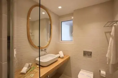 a bathroom with a sink and a mirror at Joy Luxury Central Apartment in Athens