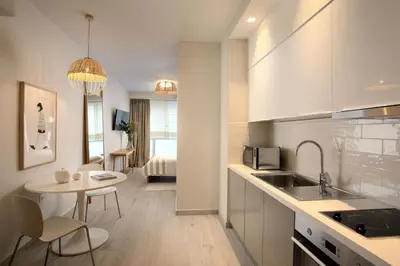 a kitchen with a sink and a table in a room at Joy Luxury Central Apartment in Athens