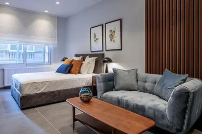 a living room with a bed and a couch at Jasmine Luxury Apartment in Athens