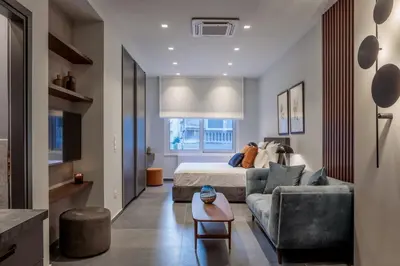 a living room with a bed and a couch at Jasmine Luxury Apartment in Athens