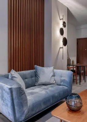 a blue couch in a living room with a table at Jasmine Luxury Apartment in Athens