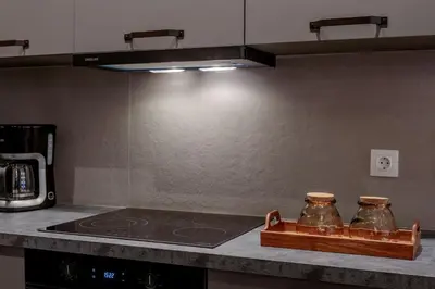 a kitchen with two glass jars on a counter at Jasmine Luxury Apartment in Athens