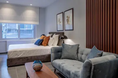 a living room with a bed and a couch at Jasmine Luxury Apartment in Athens