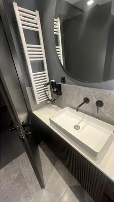 a bathroom with a sink and a mirror at Jasmine Luxury Apartment in Athens