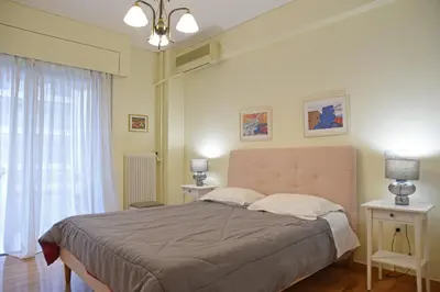 a bedroom with a large bed and a window at Athens Faliro Beach Residence, close to city center in Athens