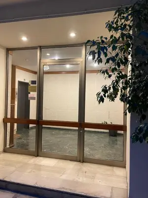 a sliding glass door in a building with a window at Athens Faliro Beach Residence, close to city center in Athens