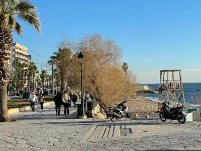a motorcycle parked on a sidewalk next to the beach at Athens Faliro Beach Residence, close to city center in Athens