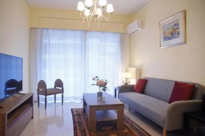 a living room with a couch and a table at Athens Faliro Beach Residence, close to city center in Athens