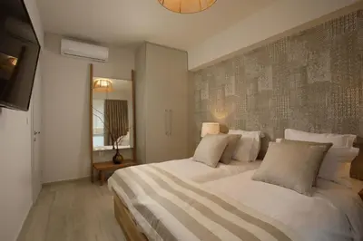 a bedroom with a large white bed and a television at Central Luxury Apartment Love in Athens