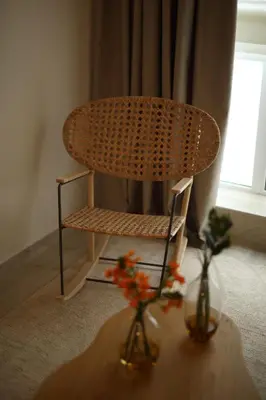 a chair and two vases on a table with flowers at Central Luxury Apartment Love in Athens