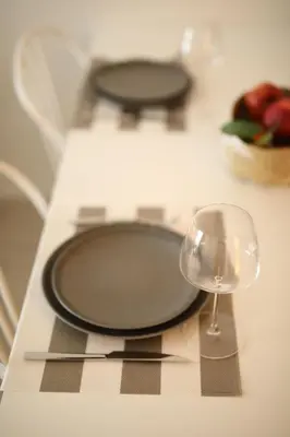 a table with a plate and a glass of wine at Central Luxury Apartment Love in Athens