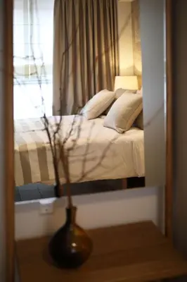 a bedroom with a bed and a vase on a table at Central Luxury Apartment Love in Athens