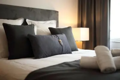 a bedroom with a large white bed with pillows at Fivos Luxury Suite in Athens