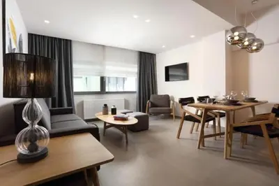 a living room with a table and a dining room at Fivos Luxury Suite in Athens