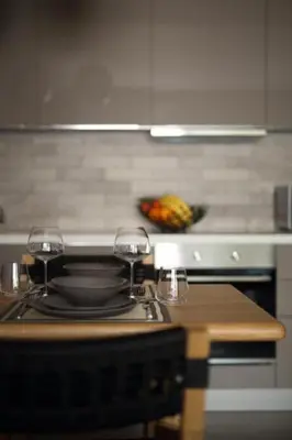 a kitchen with a stove with two wine glasses on it at Fivos Luxury Suite in Athens
