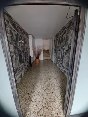 a view of a hallway in a house with a mirror at Apollo Apartment Athens/Airport in Spáta