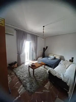 a living room with a couch and a table at Apollo Apartment Athens/Airport in Spáta