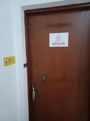 a brown door with a sign on it at Apollo Apartment Athens/Airport in Spáta