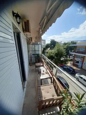 a balcony with chairs and a view of a street at Apollo Apartment Athens/Airport in Spáta