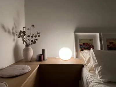 a bedroom with a table with a vase of flowers and a light at Penthouse with Private Rooftop and Hot Tub in Athens