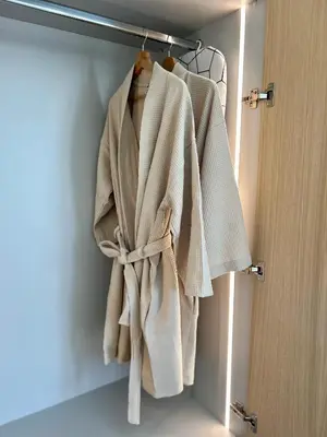 a robe hanging on a rack in a closet at Penthouse with Private Rooftop and Hot Tub in Athens