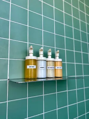 a row of bottles on a shelf in a bathroom at Penthouse with Private Rooftop and Hot Tub in Athens