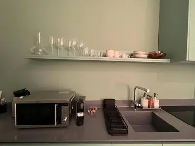 a kitchen counter with a microwave and a sink at Penthouse with Private Rooftop and Hot Tub in Athens