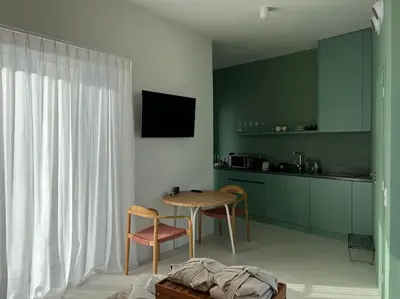 a kitchen with a table and chairs in a room at Penthouse with Private Rooftop and Hot Tub in Athens