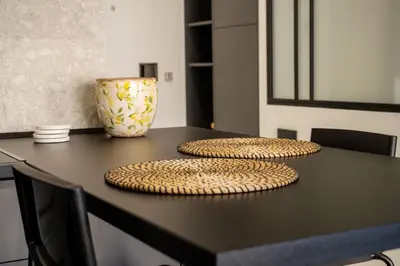 two circular plates on a black table with a vase at Kolonaki Square Central Penthouse in Athens