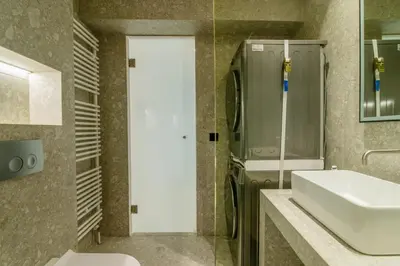 a bathroom with a white sink and a mirror at Kolonaki Square Central Penthouse in Athens