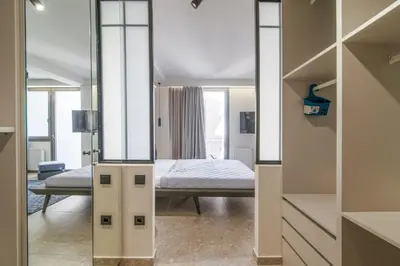 a bedroom with a bed and a mirror at Kolonaki Square Central Penthouse in Athens