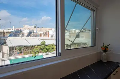 a window with a view of a city at Acropolis view apt in Koukaki in Athens