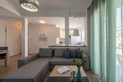 a living room with a couch and a table at Acropolis view apt in Koukaki in Athens