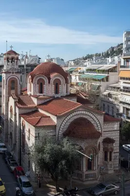 a large brick building with a red roof at Acropolis view apt in Koukaki in Athens
