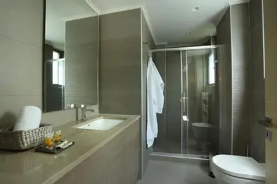 a bathroom with a sink and a toilet and a shower at Hector Luxury Suite in Athens