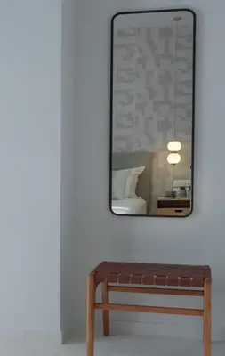 a mirror above a bench in a room at Azalea Luxury Apartment in Athens