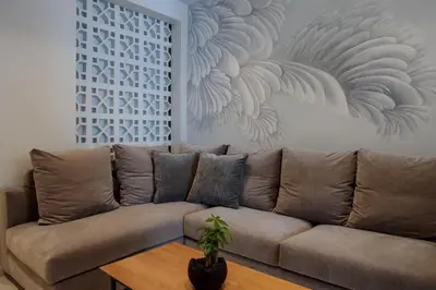 a living room with a brown couch and a table at Azalea Luxury Apartment in Athens