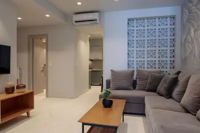 a living room with a couch and a table at Azalea Luxury Apartment in Athens
