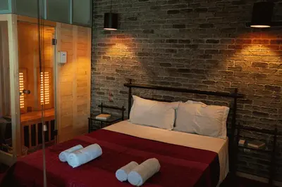 a bedroom with a bed with two towels on it at Sigma Sauna Nest in Athens